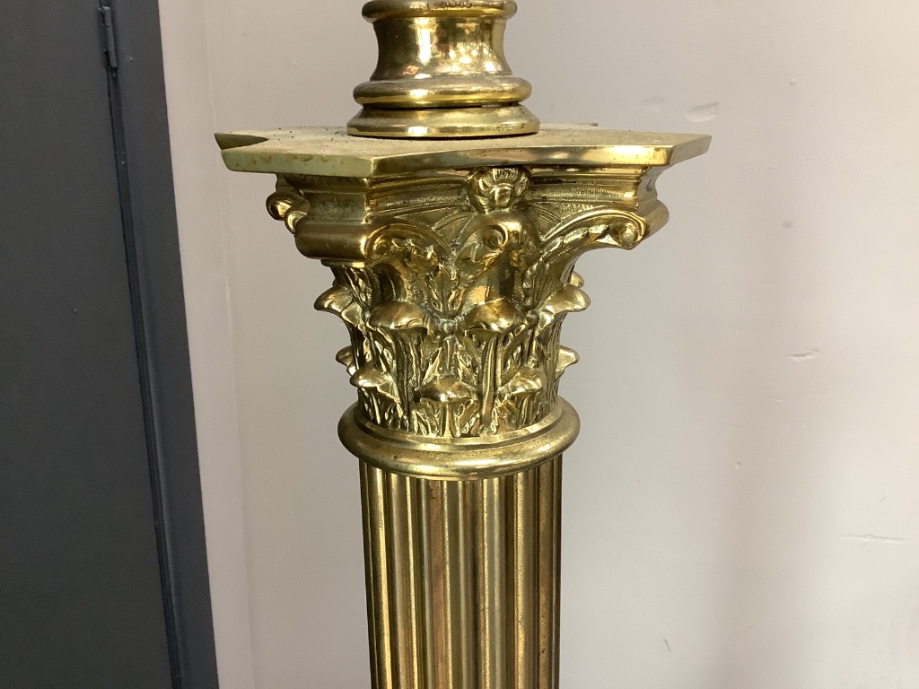 An early 20th century adjustable brass corinthian column lamp standard, minimum height 150cm